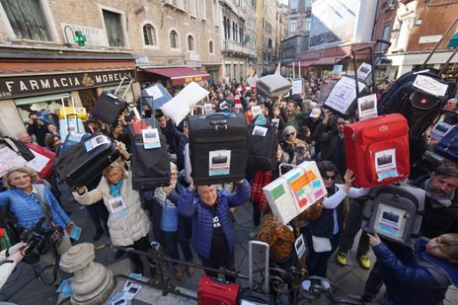 Residents of Venice hold luggages during the 'Venexodus' demonstrations in Venice, Italy. - EPA/ANDREA MEROLA